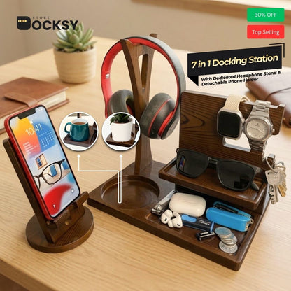 A wooden 7-in-1 docking station organizer on a light wood desk, holding a smartphone, over-ear headphones, sunglasses, a watch, earbuds, ear cases, keys, and small accessories. The image includes promotional text and inset circles showing additional use cases.